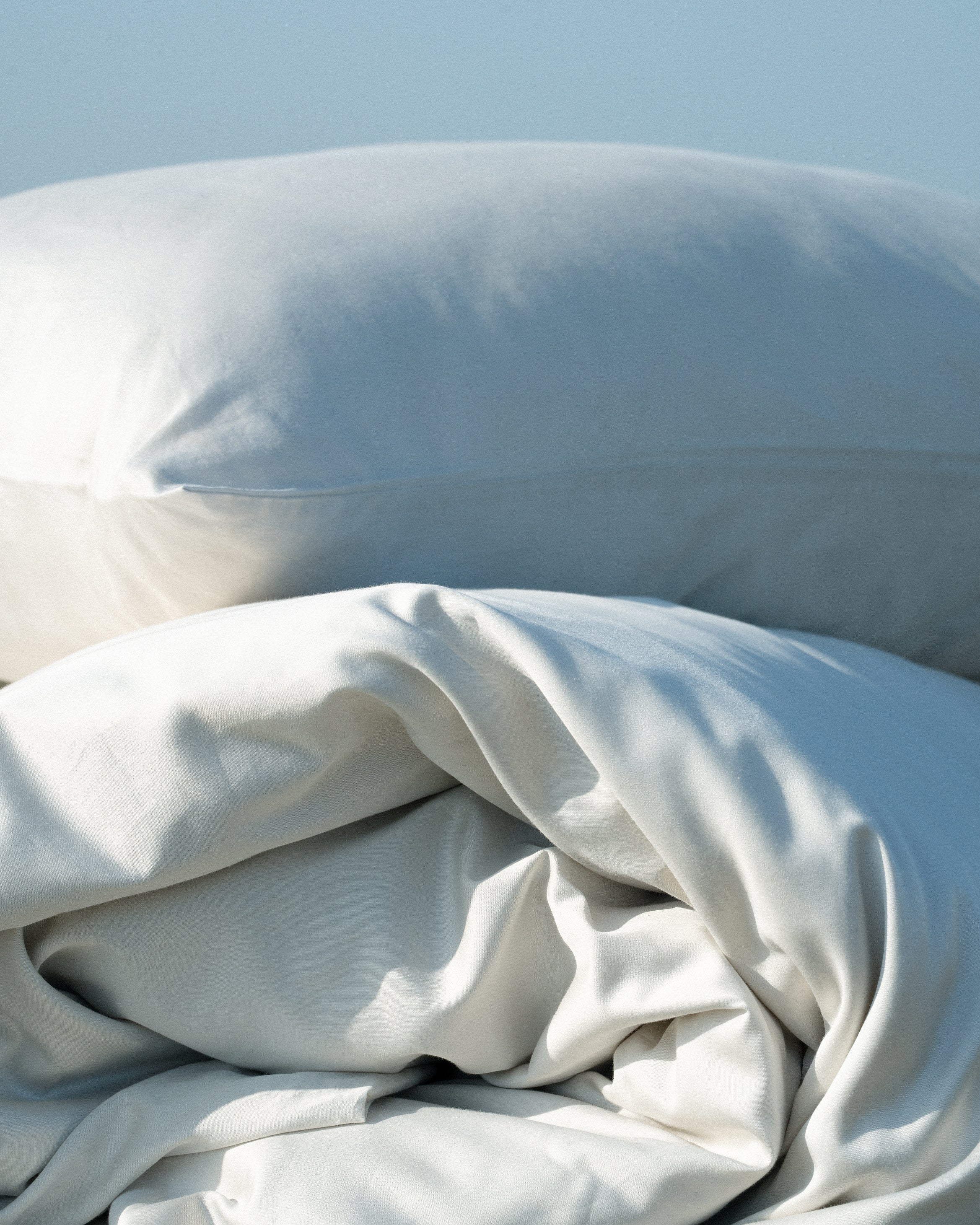 Closeup of pillow and duvet from Abate in beige color